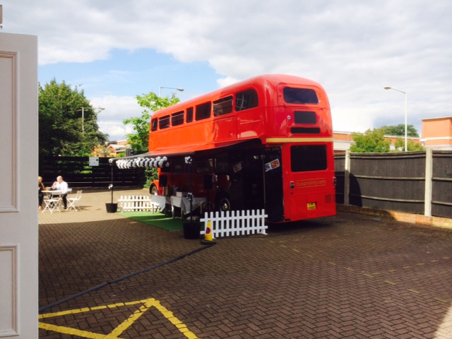 red bus black and white balloons with canopy static bus hire