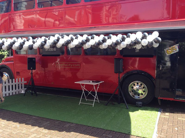 red bus black and white balloons static bus hire